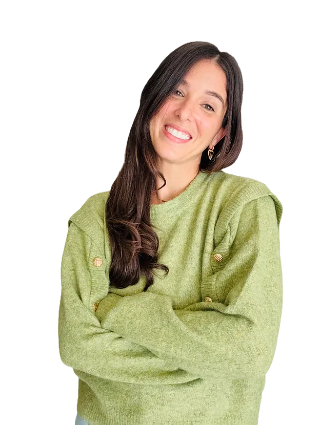 Samantha Rajchel smiling in a green sweater, arms gently crossed
